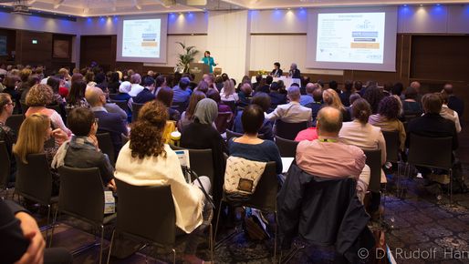 People listening to a speaker at a conference in Salzburg about clinical care and research in Epidermolysis Bullosa