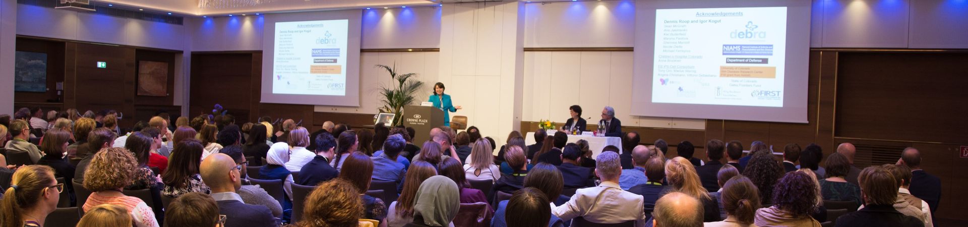 People listening to a speaker at a conference in Salzburg about clinical care and research in Epidermolysis Bullosa